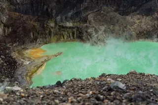 Illustration: Steam rises from a turquoise volcanic crater lake surrounded by steep rocky cliffs.